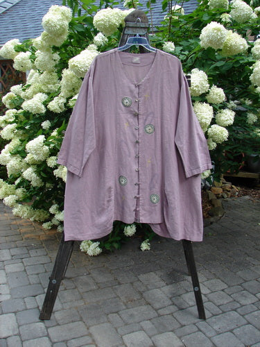 1999 Parlor Jacket Circle Florals Heliotrope Size 2 displayed on a rack, featuring nine abalone buttons, a V-shaped neckline, gathered front and back, side pockets, and a floral design.