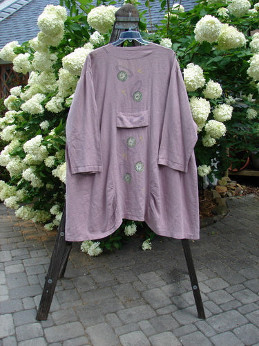 1999 Parlor Jacket Circle Florals Heliotrope Size 2 displayed on a rack, showcasing a V-shaped neckline, abalone buttons, side pockets, and a gathering front and back with a varying hemline.