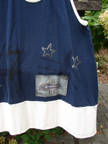 1998 8 Ball Tunic Games Crew Blue Size 1, featuring a navy sleeveless top with white trim, silvery-gray stars, and stylized patch, hanging outdoors with greenery in the background.