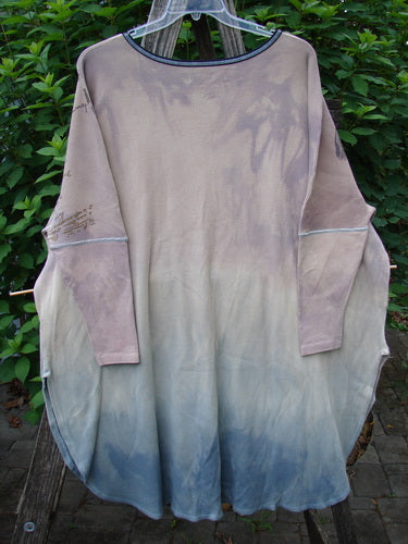 Barclay Thermal Contrast Revival Top Script Pastels OSFA displayed on a clothes hanger, showcasing its rounded ribbed neckline, tapering ribbed sleeves, and unique A-line shape with script theme paint accents.