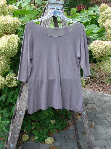 Barclay Batiste Raw Edge Layering Tee Unpainted Pebble Size 1 with three-quarter sleeves and rolled edges, elegantly displayed on a ladder, embodying Bluefishfinder.com's vintage fashion ethos.