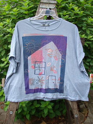 Barclay Cotton Slub Cricket Cap Sleeve Tee Sun Guy Dusty Blue OSFA displayed on a hanger, showcasing its cap sleeves, seamless shoulders, slight hip flare, and unique Sun Guy design.