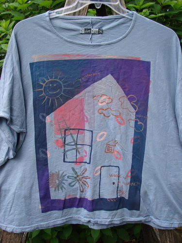 Barclay Cotton Slub Cricket Cap Sleeve Tee Sun Guy Dusty Blue OSFA features a whimsical house illustration on lightweight organic cotton, emphasizing a boxy shape with seamless shoulders and cool cap sleeves.