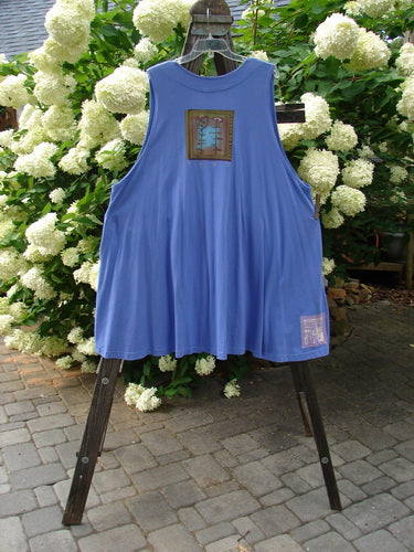 1997 Simple Vest Flower Sprig Skylark Size 2 hanging on a rack, showcasing deep side pockets, oversized knotted buttons, and a blue patch with a flower sprig theme on the lower back.