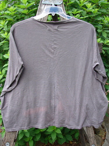 Barclay Cotton Slub Cricket Cap Sleeve Tee Primitive Pony Dark Stone OSFA, displayed on a clothes rack, highlights its seamless shoulder sleeves and unique boxy shape, reflecting Bluefishfinder.com's vintage style.