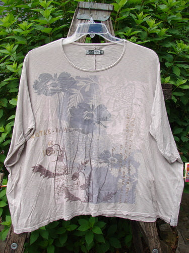 Barclay Cotton Slub Cricket Cap Sleeve Tee Poppy Garden Mist OSFA displayed on a swinger, showcasing its seamless shoulder sleeves, slight hip flare, and rounded hemline with a floral design.