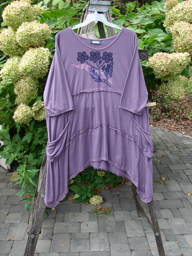 Barclay NWT Raw Seam Vector Tunic Dress Tri Floral Violet Size 2 features a loose fit, decorative seams, stylized floral and bird graphic, and draped pockets, reflecting Bluefishfinder.com's vintage, expressive style.