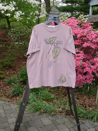 1998 Botanicals Short Sleeved Tee Turn Leaf Passiflora Size 2, displayed on a hanger, showcasing its boxy shape and turn leaf design with a softly ribbed neckline.