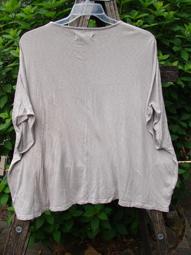 Barclay Cotton Slub Cricket Cap Sleeve Tee Poppy Garden Mist OSFA displayed on a clothes rack, showcasing its seamless shoulder sleeves, cap sleeves, and unique poppy garden theme with a slightly flared hip design.