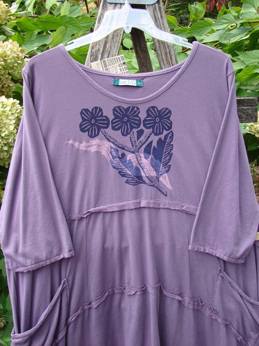 Barclay NWT Raw Seam Vector Tunic Dress Tri Floral Violet Size 2, features a loose fit with tiered seams, floral motif, exterior drop pockets, and a unique dip side hemline, ideal for creative expression.