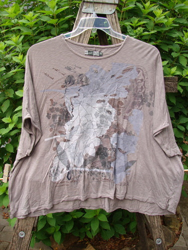 Barclay Cotton Slub Cricket Cap Sleeve Tee Leaf Play Light Stone OSFA displayed on a swinger, showcasing its seamless shoulder sleeves, cap sleeves, and rounded hemline with unique leaf-themed paint design.