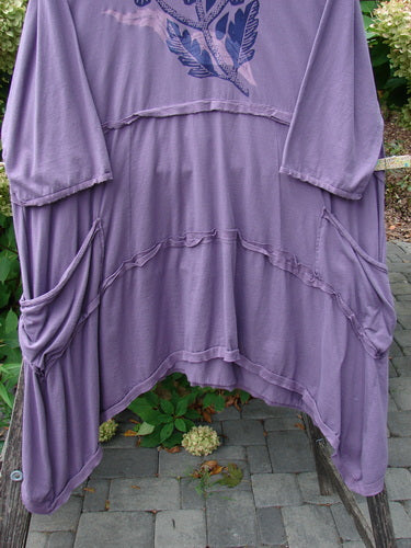 Barclay NWT Raw Seam Vector Tunic Dress Tri Floral Violet Size 2 features a soft lavender jersey knit with batwing sleeves, raw edges, draped side pockets, and a distinctive upward gathered front.