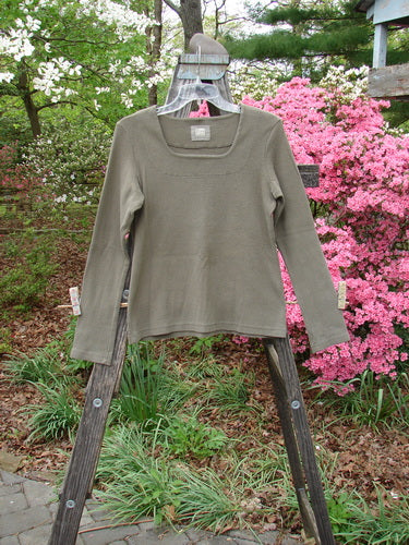 1999 Square Neck Rib Top Unpainted Mud Size 1 displayed on a wooden ladder, showcasing its thick ribbed material, squared neckline, and slight A-line flare, perfect for layering from Bluefishfinder.com.