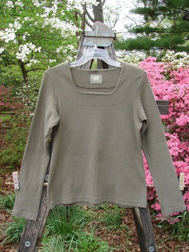 1999 Square Neck Rib Top Unpainted Mud Size 1 displayed on a wooden stand, showcasing its long sleeves, thick ribbed material, and squared double-paneled neckline with slight A-line flare.
