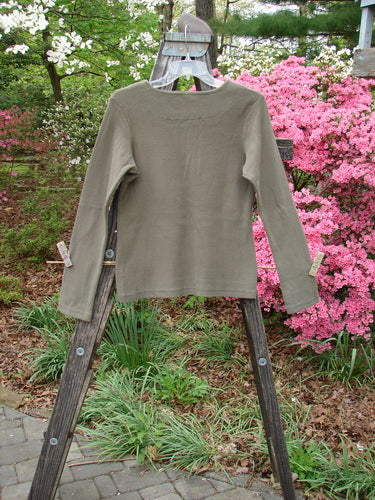 1999 Square Neck Rib Top Unpainted Mud Size 1 displayed on a wooden rack, showcasing its thick ribbed material and squared double-paneled neckline with a slight A-line flare.