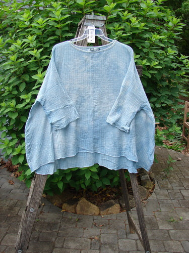 Barclay NWT Crinkle Gauze Top Mottled Smokey Sky Blue OSFA displayed on a wooden stand, showcasing its wide, boxy silhouette and three-quarter dolman sleeves, reflecting Bluefishfinder.com's vintage, expressive style.