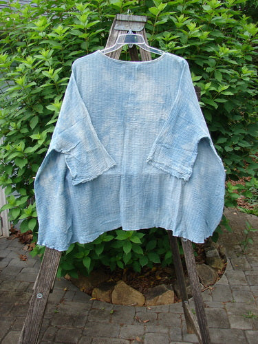 Barclay NWT Crinkle Gauze Top Mottled Smokey Sky Blue OSFA displayed on a hanger, showcasing its wide, boxy shape, high-low hemline, and three-quarter-length dolman sleeves.