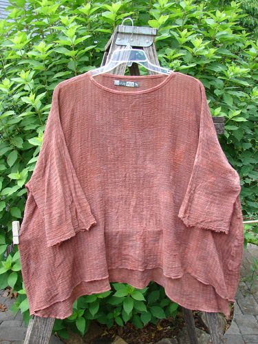 Barclay Crinkle Gauze Top Mottled Monrovian Brick OSFA displayed on a hanger, features a flowing silhouette with three-quarter dolman sleeves, high-low hemline, and shallow neckline, embodying Bluefishfinder.com's vintage style.