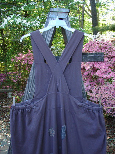 1995 Omega Jumper Magic Leaf Bloomsberry OSFA displayed on a wooden cross, featuring sectional panels, stoneware buttoned front pocket, and apron style look with a double-layered waistband.