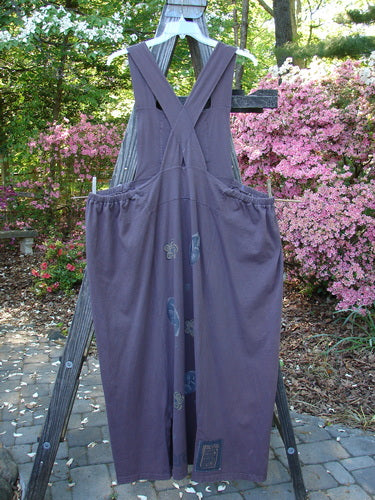 1995 Omega Jumper Magic Leaf Bloomsberry OSFA displayed on a wooden stand, showcasing its detailed front bib with stoneware buttoned front pocket, sectional panels, and apron-style look.