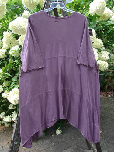 Barclay Vertical Gather Drop Pocket Dress Unpainted Dusty Plum Size 2 displayed on a hanger, showcasing its unique dip side hemline, front vertical gather, and two exterior front drop pockets.