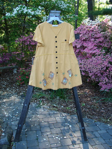 1998 Baseball Dress Games Lemonade Size 0 displayed on a rack, featuring a deep V-neckline, dark contrasting buttons, paneled breast pocket, drop waist seam, and generous A-line lower sweep.