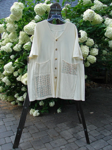 2000 Double Decker Pocket Top Pastel Fence Milk Size 2 displayed on a rack, featuring two front oversized pockets stacked on top of each other.