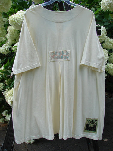 2000 Double Decker Pocket Top Pastel Fence Milk Size 2 displayed on a mannequin, showcasing two front oversized pockets and a pleated back with signature Blue Fish Patch and pastel garden fencing design.