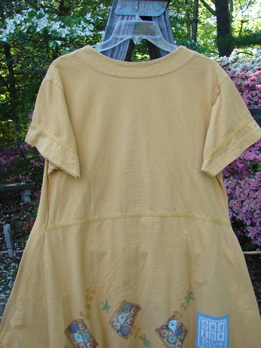 1998 Baseball Dress Games Lemonade Size 0 hanging on a clothesline, showcasing its V-shaped neckline, dark contrasting buttons, paneled breast pocket, and A-line lower sweep.