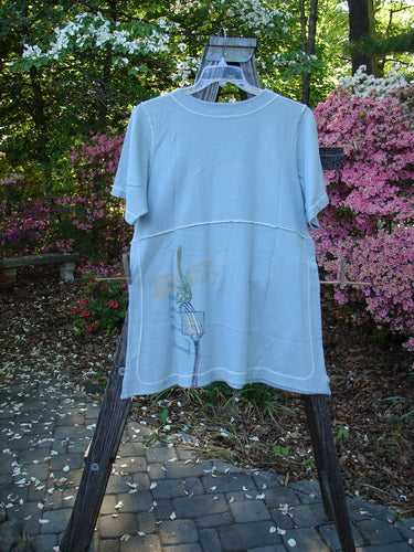 1998 Botanicals Snapdragon Top Birdsong Size 1 displayed on a hanger, showcasing its flared shape, rounded neckline, tall vented sides with button and loop accents, and exterior stitchery.