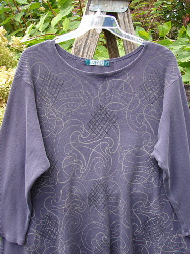 Barclay Thermal A Lined Top Spirograph Plum Size 2, featuring a scoop-neck, long sleeves, and abstract swirl print, displayed on a hanger over a ladder, embodying Bluefishfinder.com's vintage style.