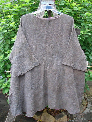 Barclay NWT Crinkle Gauze Ana Tunic Dress in Mottled Latte displayed on a clothes rack, showcasing its wide three-quarter sleeves, seamless shoulder, and varying hemline, embodying Bluefishfinder.com's vintage style.