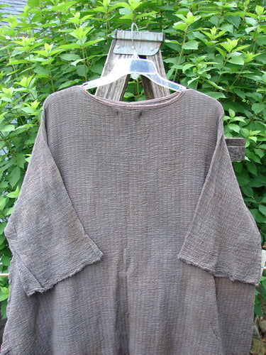 Barclay NWT Crinkle Gauze Ana Tunic Dress Unpainted Mottled Latte OSFA displayed on a wooden stand; features wide three-quarter sleeves, seamless shoulders, and a varying hemline in lightweight cotton gauze.