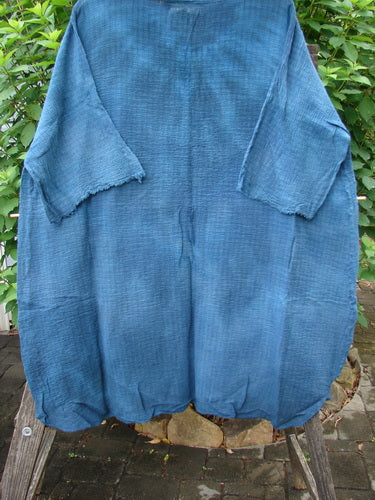 Barclay NWT Crinkle Gauze Ana Tunic Dress in Mottled Teal, featuring a shallow rounded neckline, wide three-quarter sleeves with frays, and a varying hemline, displayed elegantly to highlight its unique design.