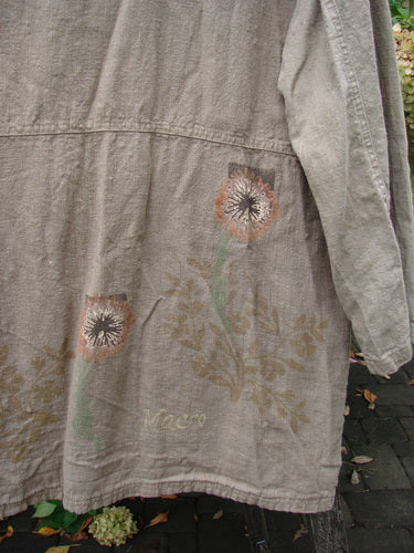 1998 Botanicals Herbary Jacket Dandelion Drift Dust Size 1 displayed on a garden chair, featuring stylized thistle motifs on the back hem and faint Macro lettering above, embodying vintage charm and unique botanical design.