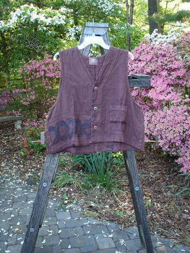 2000 Poet's Vest Celtic Loam Size 1 displayed on a wooden ladder, showcasing unique front seams, double-paneled hemline, feather edge pocket, and metal buttons from the 2000 Fall Collection.