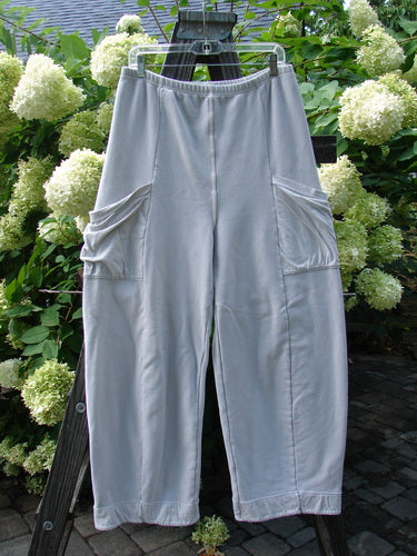 Barclay Interlock Cuff Toboggan Reversible Pant Unpainted Pebble Size 1 displayed on a rack, showcasing fleece cuffs and oversized side pockets, highlighting its reversible feature with detailed stitchery.