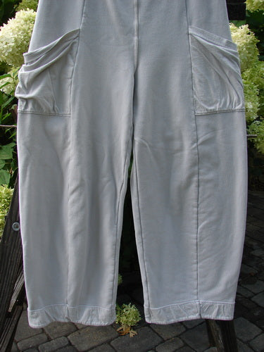 Barclay Interlock Cuff Toboggan Reversible Pant Unpainted Pebble Size 1 displayed on a rack, showcasing its fleece cuffs, elastic waistline, and oversized side pockets in a heavy stretch cotton interlock fabric.