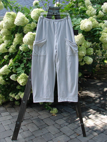 Barclay Interlock Cuff Toboggan Reversible Pant Unpainted Pebble Size 1 displayed draped over a ladder, highlighting its fleece cuffs and oversized side pockets, reflecting Bluefishfinder.com's unique vintage style.