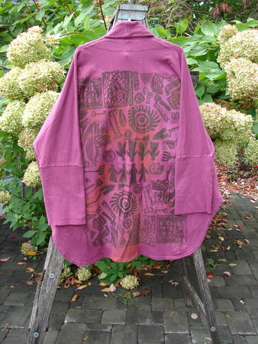 Barclay NWT Reprocessed Golden Hour Jacket Rear Folk Garden Pokeberry OSFA displayed outdoors, featuring abstract tribal motifs on the back, with long sleeves, deep V-neckline, and oversized pockets.