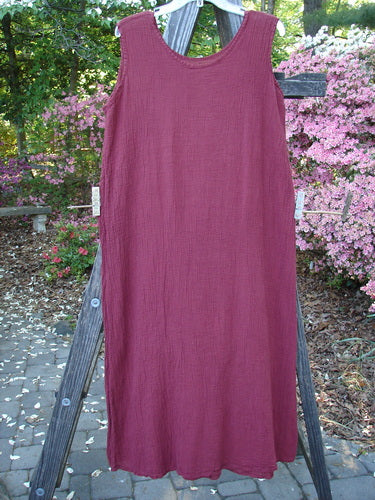 Barclay Gauze Seamless A Line Pinafore Shift Unpainted Red Wine Size 1 displayed on a clothes rack, showcasing its slight A-line shape and shallow neckline.