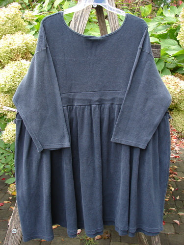 1992 Thermal Circus Dress Unpainted Black Size 2, a long-sleeved, dark-bluish tunic with a wide scoop neckline and dropped waist, featuring a full pleated skirt and original metal grommets.