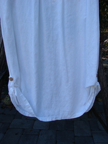 1999 Textured Linen Water Dress Garden Friends White Size 0, showcasing a loose-fitting design with a rounded hem and button detail, hanging outdoors, highlighting its vintage charm and unique linen texture.