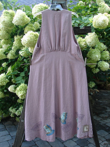 1999 Patio Jumper Fancy Bake Bowls Heliotrope Size 0, sleeveless with deep arm openings, scooped rear waist seam, shell button pocket, flowy A-line shape, gathered upper rear shoulder section, hanging on a clothesline.