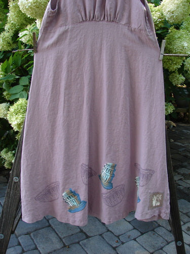 1999 Patio Jumper Fancy Bake Bowls Heliotrope Size 0: A sleeveless linen jumper with deep arm openings, a rounded rear waist seam, shell button pocket, and gathered upper rear shoulder section.