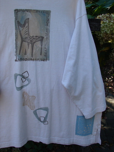 1995 Stargazer Jacket Chair Row China OSFA, featuring a stylized chair motif and abstract shapes, hangs in front of foliage. It showcases a unique blend of artistic designs, embodying BlueFishFinder's vintage charm.