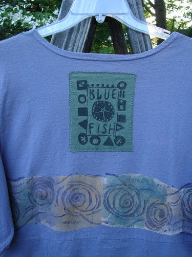 1993 3 Square Dress Wind Band Periwinkle OSFA: Vintage dress with a rounded neckline, vertically curved lines, six sectional panels, and a large rear signature Blue Fish patch. Rare collectible from the 1993 Spring Collection.