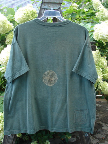 1994 Short Sleeved Tee with circular fan fare design on green tee. Vintage Blue Fish Clothing. One size fits all.