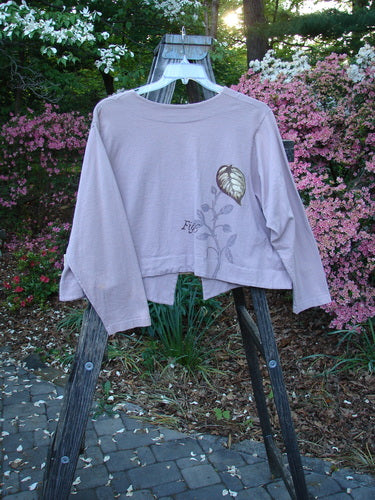 1998 Botanicals Calla Jacket Leaf Passiflora Size 1 displayed on a wooden ladder, showcasing its unique front single ceramic closure and exaggerated pointed hemline in a botanical theme.