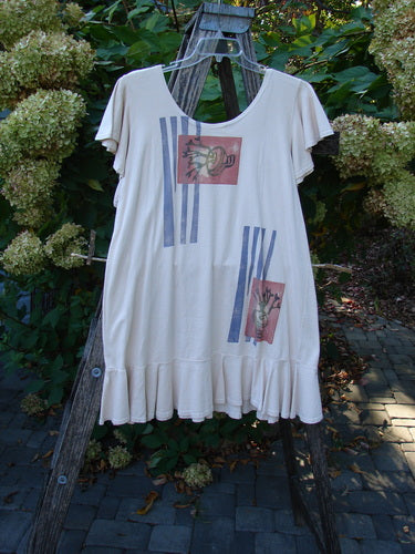 1996 Butterfly Dress Garden Path Birch Bark Size 1 features a cream tunic with ruffled sleeves and hem, adorned with fish prints and blue stripes, displayed on a wooden easel amidst greenery.